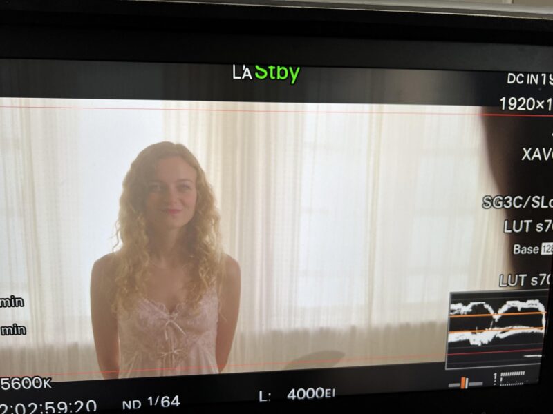 Camera monitor on set shows Sille Schnoor in a scene in front of a light curtain